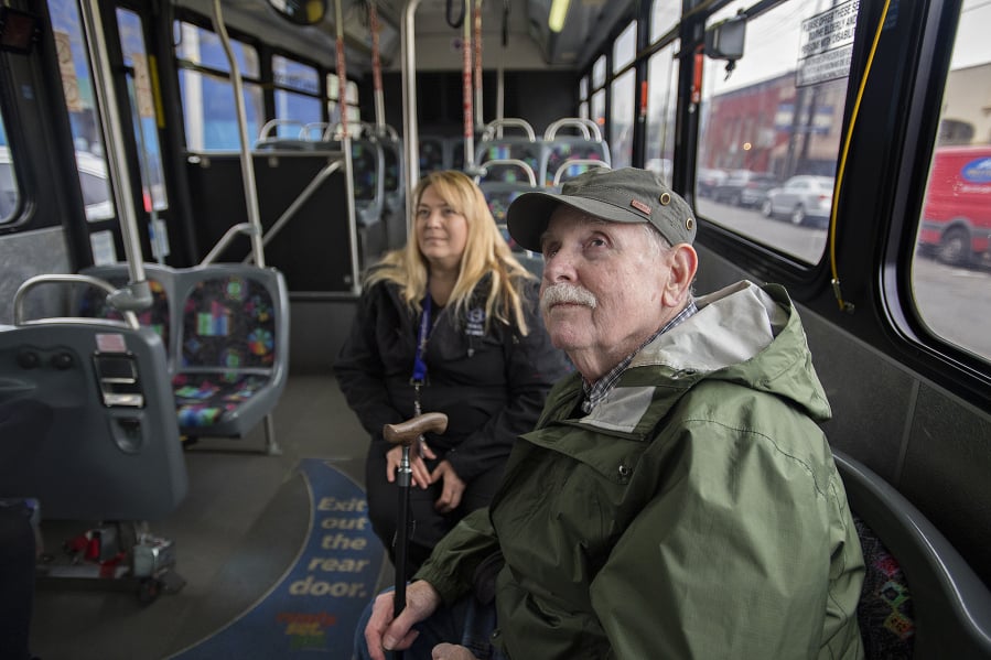 Vancouver resident John Prince, front, catches a ride downtown on the bus Tuesday with Veronica Marti, lead travel trainer for C-Tran. The Clark County Commission on Aging is recommending that the county improve connectivity for seniors.