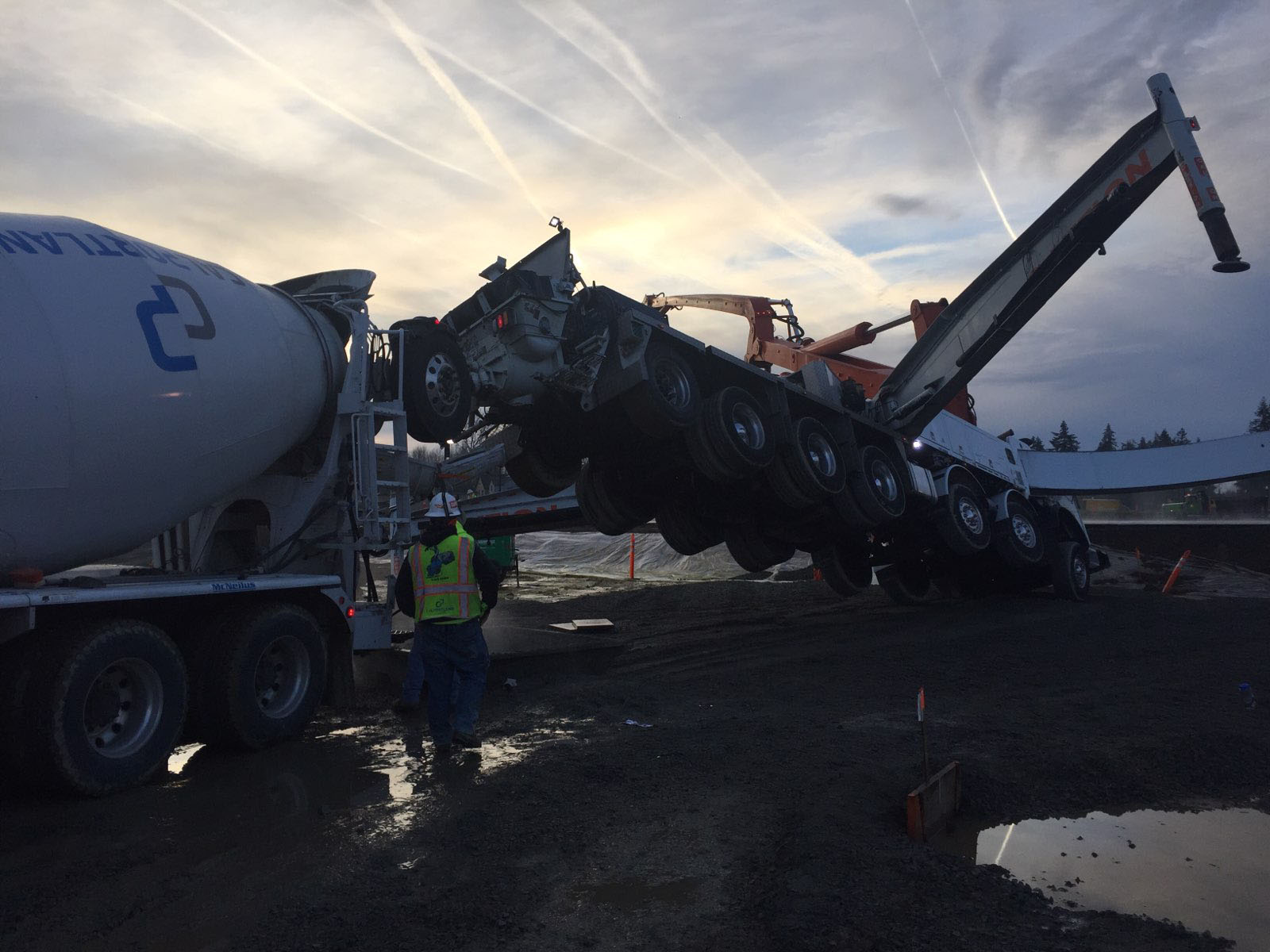 The driver of a concrete mixer truck was seriously injured Friday morning after a concrete pump truck tipped, launching him off of a ladder and into nearby equipment, at a construction site in the 7100 block of South 10th Street in Ridgefield.
