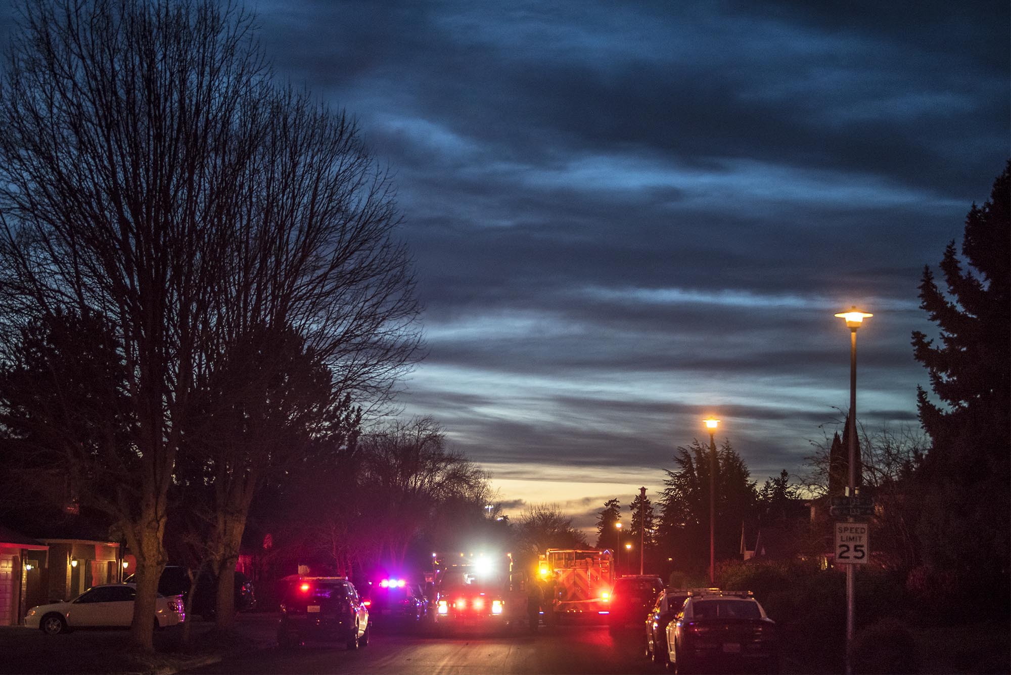 Emergency vehicles block off access to the scene of a stabbing late Friday afternoon at a home in the 13100 block of Southeast Angus Street in east Vancouver.
