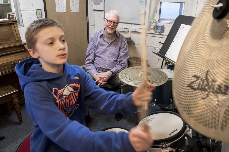 D.J. Trussler, 12, plays “The Shortest Straw” by Metallica on the drums while Jim Pitts, drum instructor at the Opus School of Music, watches during a lesson at the Ridgefield location, 414 Pioneer St.