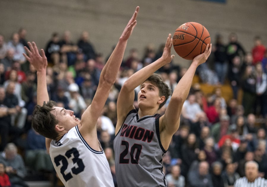 Skyview’s Kyle Gruhler (23) jumps to block Union’s Josh Reznick (20) during Tuesday night’s game at Skyview.
