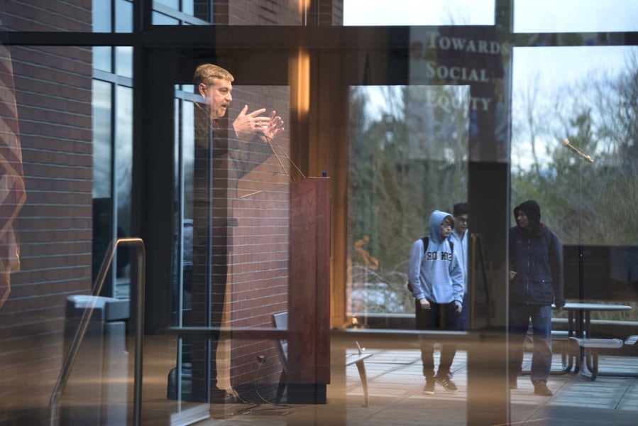 Clark College President Bob Knight speaks Thursday while students walk past during the annual State of the College address. Knight pledged to continue supporting Clark College’s diverse student body, and touted some of the gains the college has made toward promoting equity.