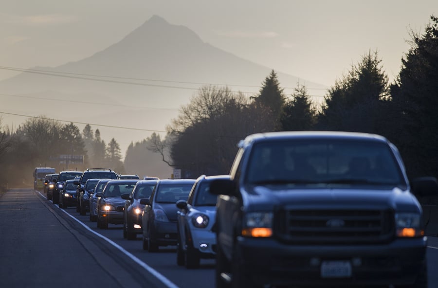 The outline of Mount Hood rises behind westbound morning traffic on state Highway 14 near the intersection of Interstate 205 on Tuesday. A $25 million state project will seek to reduce congestion by widening the freeway.