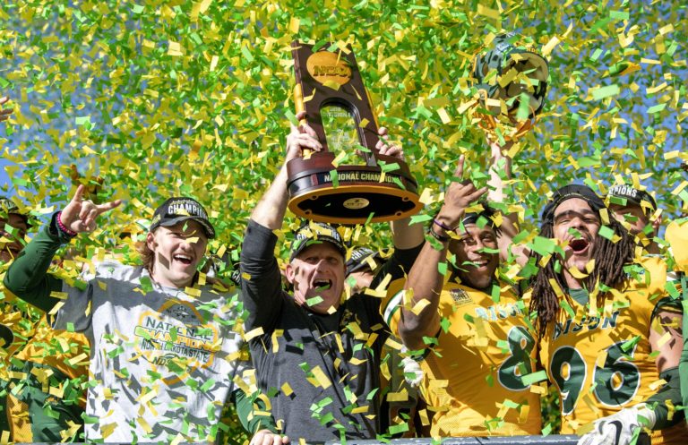 North Dakota State head coach Chris Klieman and his players hoist the trophy after beating Eastern Washington 38-24 in the FCS championship NCAA college football game, Saturday, Jan. 5, 2019, in Frisco, Texas.