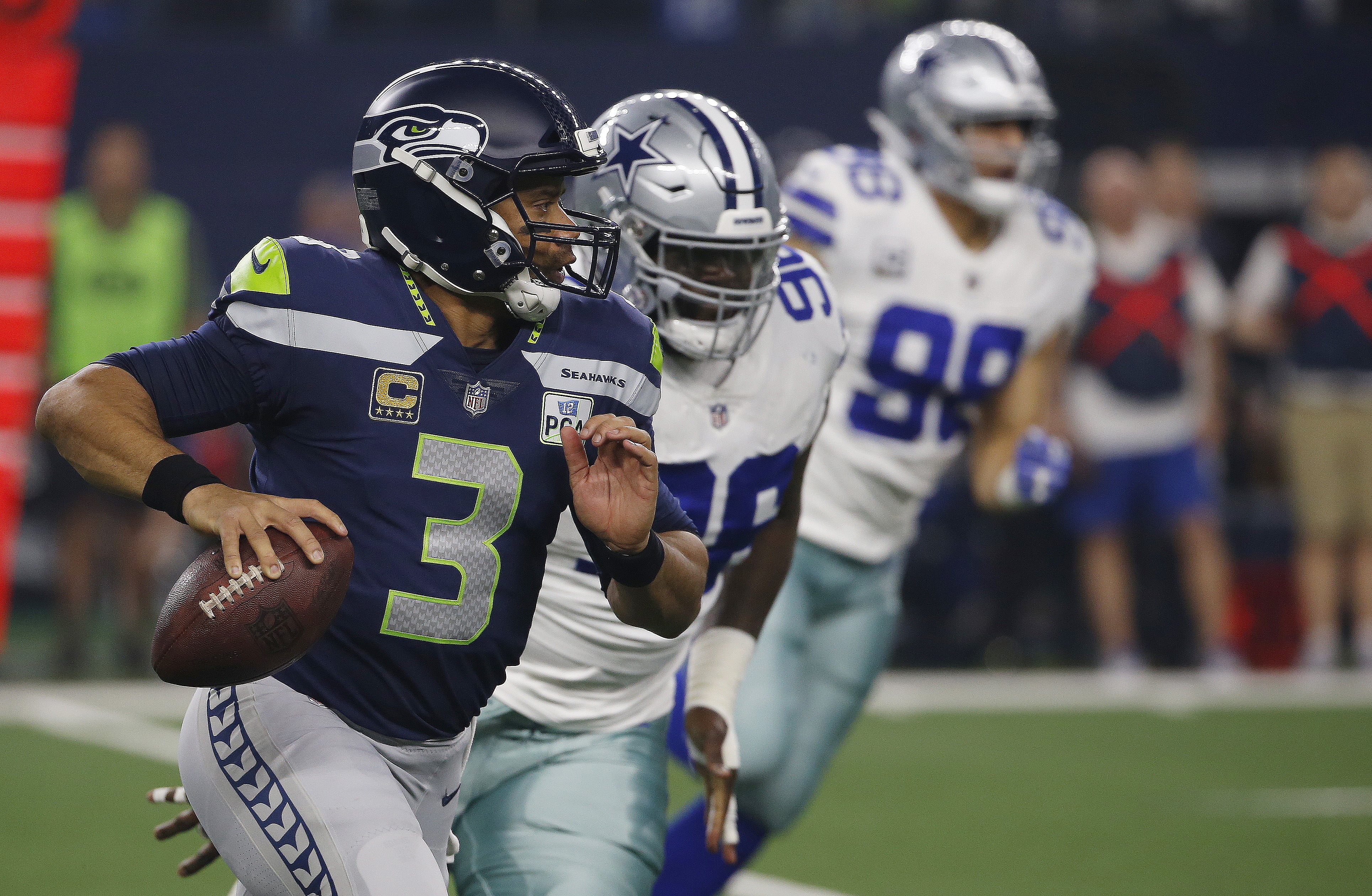 Seattle Seahawks quarterback Russell Wilson (3) runs out of the pocket against the Dallas Cowboys during the first half of the NFC wild-card NFL football game in Arlington, Texas, Saturday, Jan. 5, 2019.
