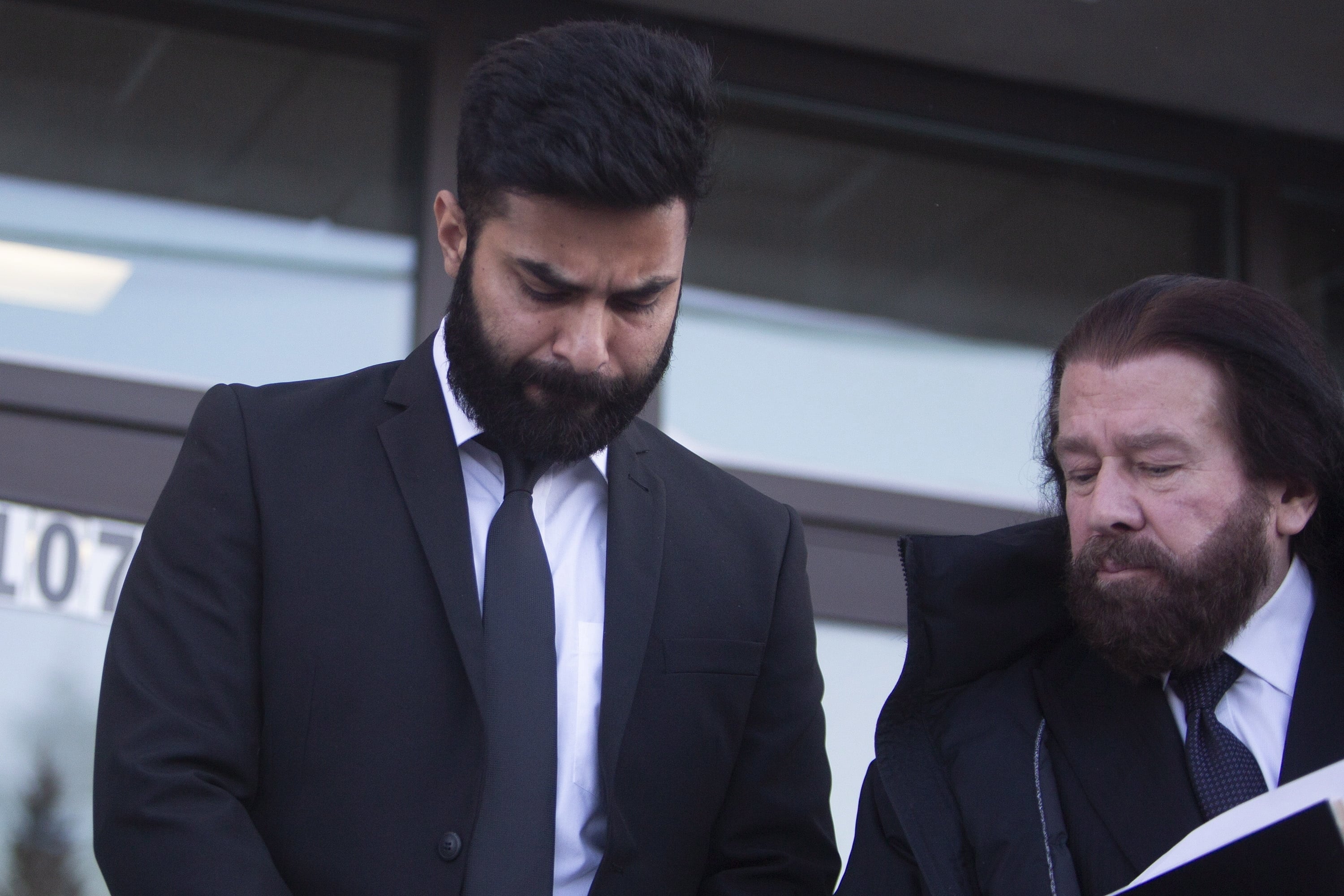 Jaskirat Singh Sidhu leaves provincial court with his lawyer Mark Brayford, right, in Melfort, Saskatchewan, Tuesday, Jan. 8, 2019. Sidhu, the driver of a transport truck involved in a bus crash that killed 16 people with the Humboldt Broncos junior hockey team in Canada last year has has pleaded guilty to all charges against him. Sidhu was charged with 16 counts of dangerous driving causing death and 13 charges of dangerous driving causing bodily harm.