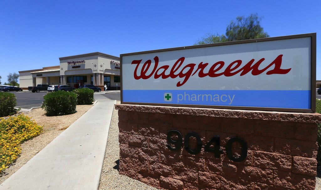 FILE - This June 25, 2018 file photo shows Walgreens in Peoria, Ariz.  The drugstore chain  is working with Microsoft to improve care, as more companies seek ways to manage patient health, cut costs and improve quality. The companies said Tuesday, Jan. 15, 2019 that they will work to improve care in part by using patient information and the Walgreens store network.  (AP Photo/Ross D.