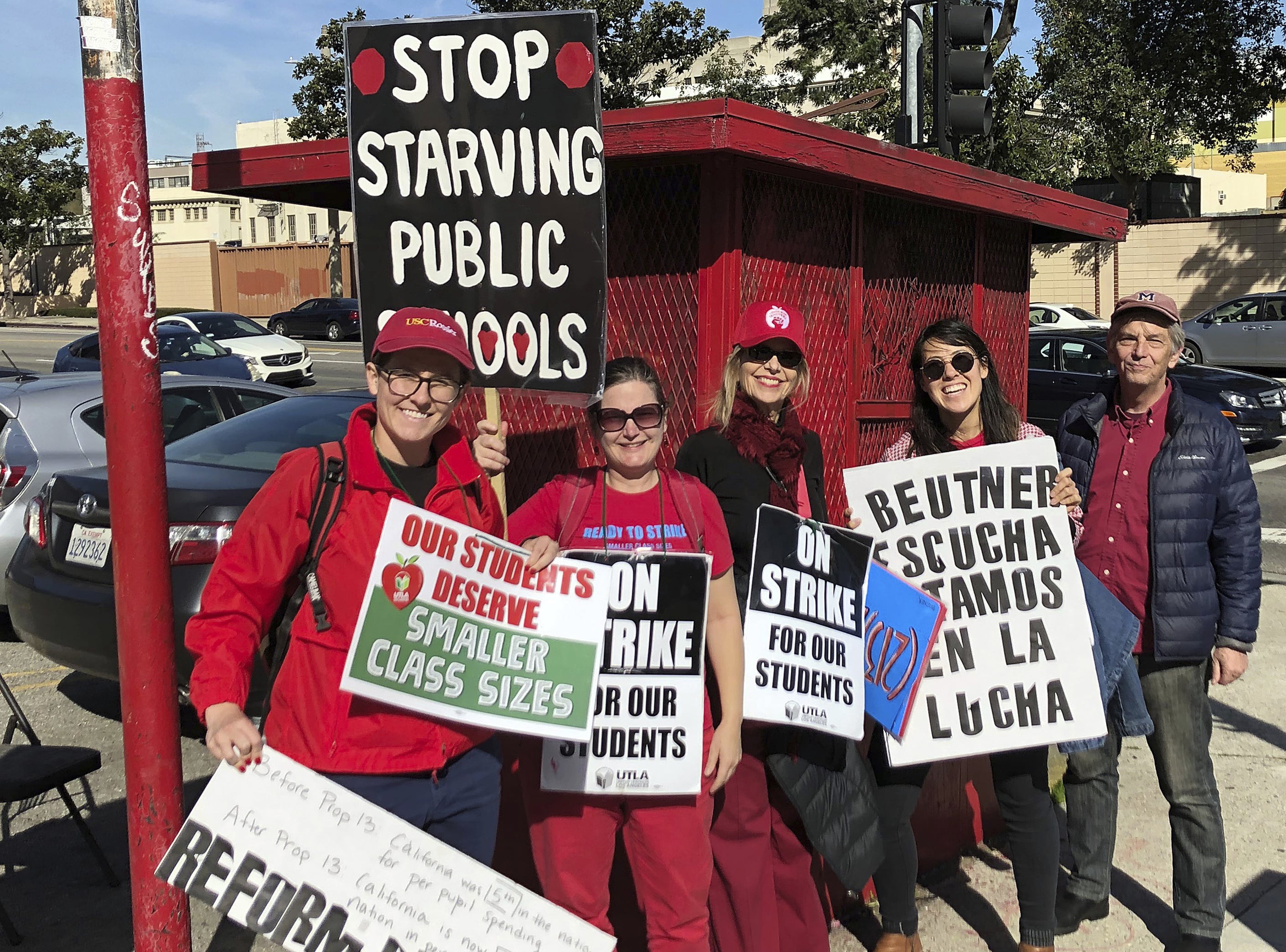 Marianne O'Brien, second from right, and her fellow teachers pose in downtown Los Angeles after rallying at City Hall, Tuesday, Jan. 22, 2019. A tentative deal between Los Angeles school officials and the teachers union will allow educators to return to classrooms after a six-day strike in the nation's second-largest district. O'Brien said she was ready to support the contract but would consider voting "No" if schools don't get additional support staff like nurses and counselors.