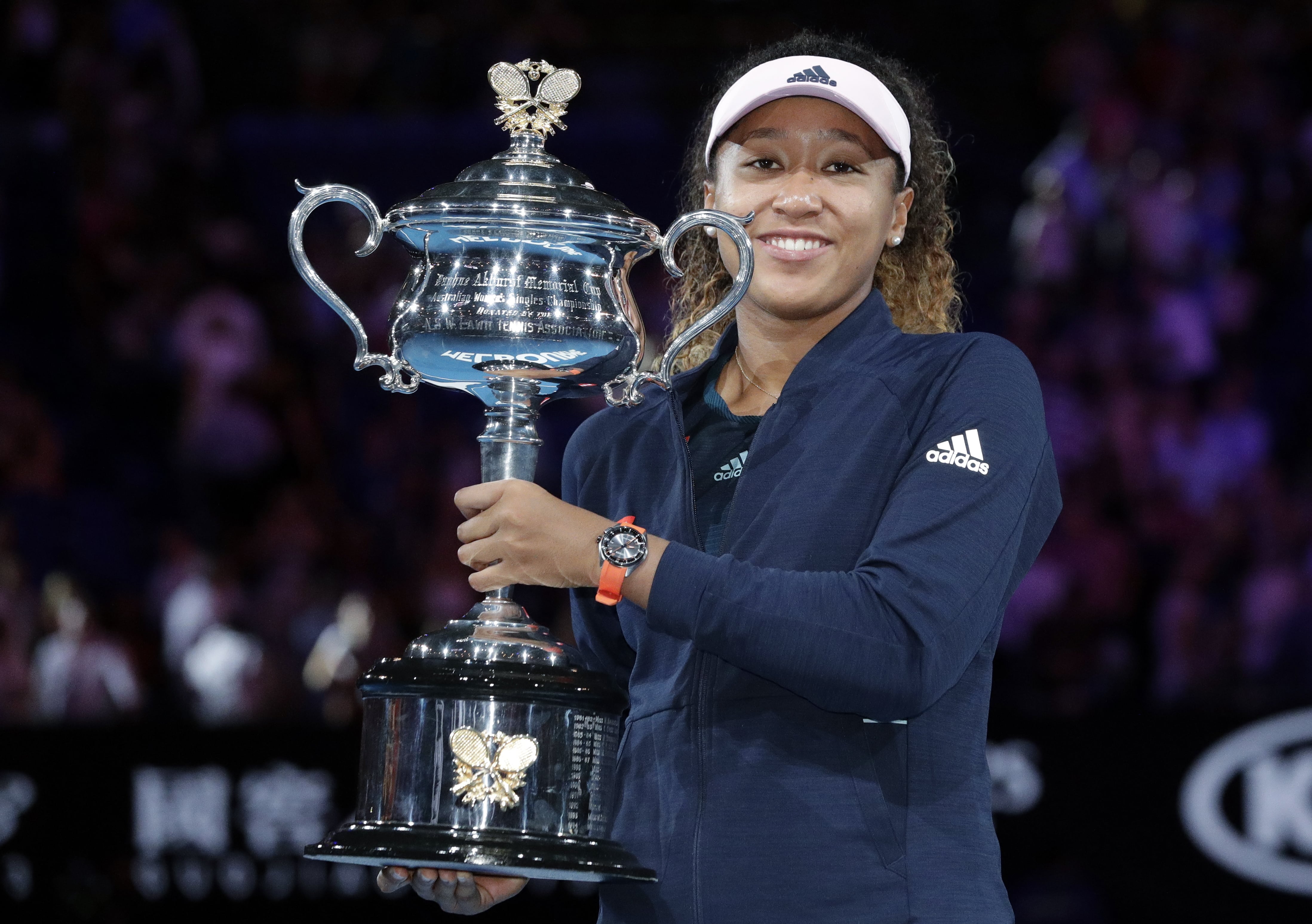 Japan's Naomi Osaka poses with her trophy after defeating Petra Kvitova of the Czech Republic in the women's singles final at the Australian Open tennis championships in Melbourne, Australia, Saturday, Jan. 26, 2019.