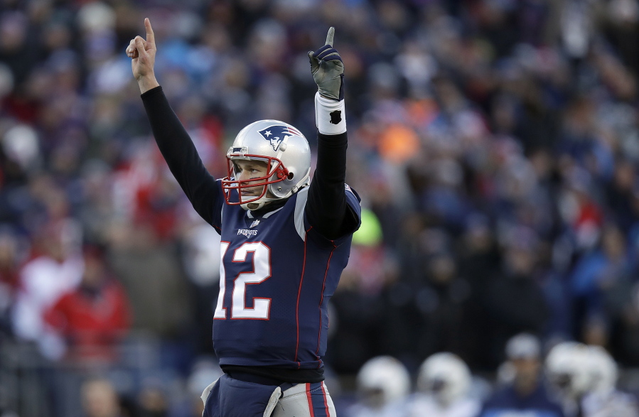 New England Patriots quarterback Tom Brady celebrates a touchdown run by running back Sony Michel during the first half of an NFL divisional playoff football game against the Los Angeles Chargers, Sunday, Jan. 13, 2019, in Foxborough, Mass.