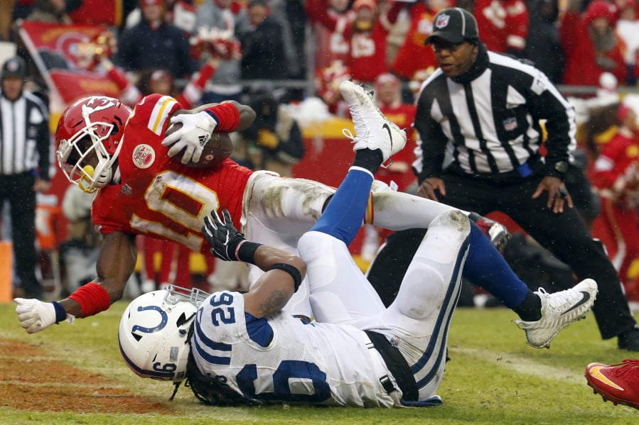 Kansas City Chiefs wide receiver Tyreek Hill (10) scores a touchdown past Indianapolis Colts safety Clayton Geathers (26) during the first half of an NFL divisional football playoff game in Kansas City, Mo., Saturday, Jan. 12, 2019.