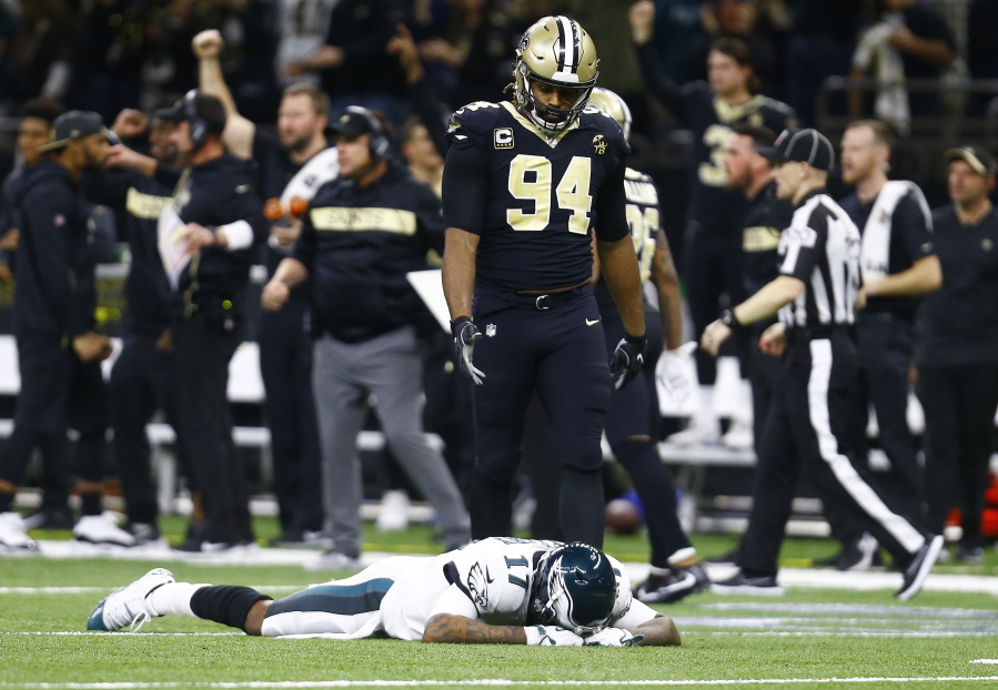 Philadelphia Eagles wide receiver Alshon Jeffery (17) lies on the turf in front of New Orleans Saints defensive end Cameron Jordan (94) after the Saints intercepted a pass in the second half of an NFL divisional playoff football game in New Orleans, Sunday, Jan. 13, 2019. The Saints won 20-14.