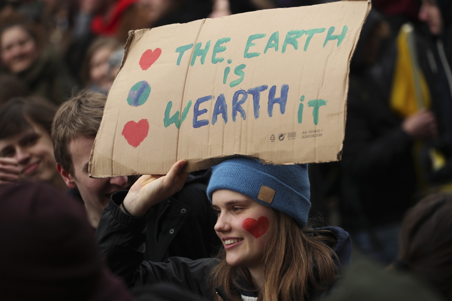 A young woman holds up a board as she marches with others during a climate change protest in Brussels, Thursday, Jan. 31, 2019. Thousands of teenagers in Belgium have skipped school for the fourth week in a row in an attempt to push authorities into providing better protection for the world’s climate.