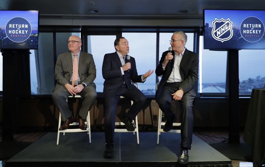 NHL Commissioner Gary Bettman, center, joins Deputy Commissioner Bill Daly, left, and Tod Leiweke, right, president and CEO of the Seattle Hockey Partners group, Wednesday, Jan. 9, 2019, during a news conference in Seattle. Bettman said the NHL has promised Seattle it will host the hockey All-Star Game within its first seven seasons. (AP Photo/Ted S.