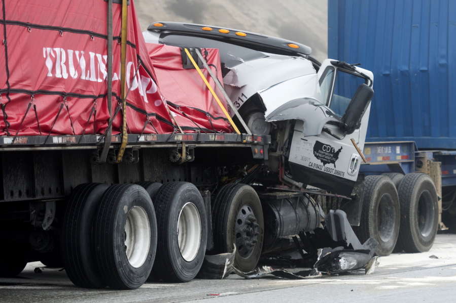 Damaged trucks remain on Interstate 15 after a multi-car collision in the Cajon Pass near Hesperia Calif., on Wednesday Jan. 16, 2019.