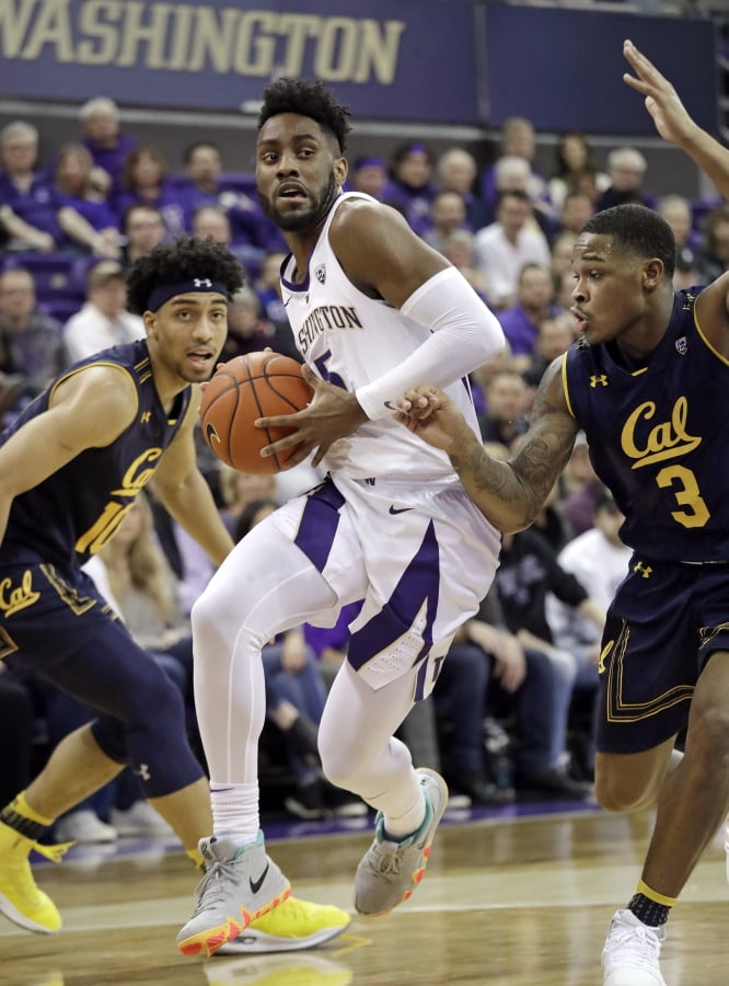 Washington’s Jaylen Nowell, center, drives between California’s Justice Sueing, left, and Paris Austin during the first half of an NCAA college basketball game Saturday, Jan. 19, 2019, in Seattle.