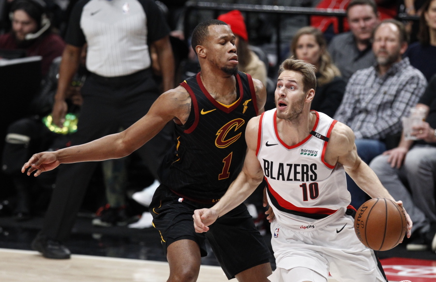 Portland Trail Blazers forward Jake Layman, right, drives against Cleveland Cavaliers guard Rodney Hood during the first half of an NBA basketball game in Portland, Ore., Wednesday, Jan. 16, 2019.