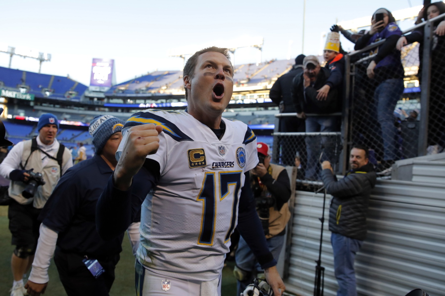 Los Angeles Chargers quarterback Philip Rivers celebates as he walks off the field after an NFL wild card playoff football game against the Baltimore Ravens, Sunday, Jan. 6, 2019, in Baltimore. Los Angeles won 23-17.