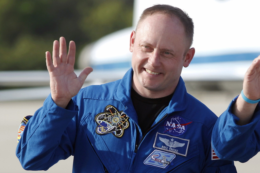 FILE - In this Tuesday, March 29, 2011 file photo, space shuttle Endeavour crew member Mike Fincke waves to onlookers after arriving for a practice countdown at Kennedy Space Center in Cape Canaveral, Fla. On Tuesday, Jan. 23, 2019, astronaut Eric Boe was pulled from the upcoming test flight for unspecified medical reasons, after more than three years of training. Taking his seat will be Fincke, a former space station commander.