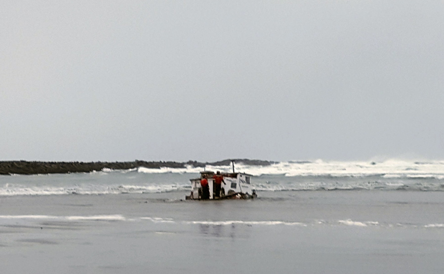 Authorities in Newport, Ore., examine the wreckage of the Mary B. II on Tuesday. The commercial crabbing vessel capsized while crossing Yaquina Bay bar off the coast of Newport, Ore.