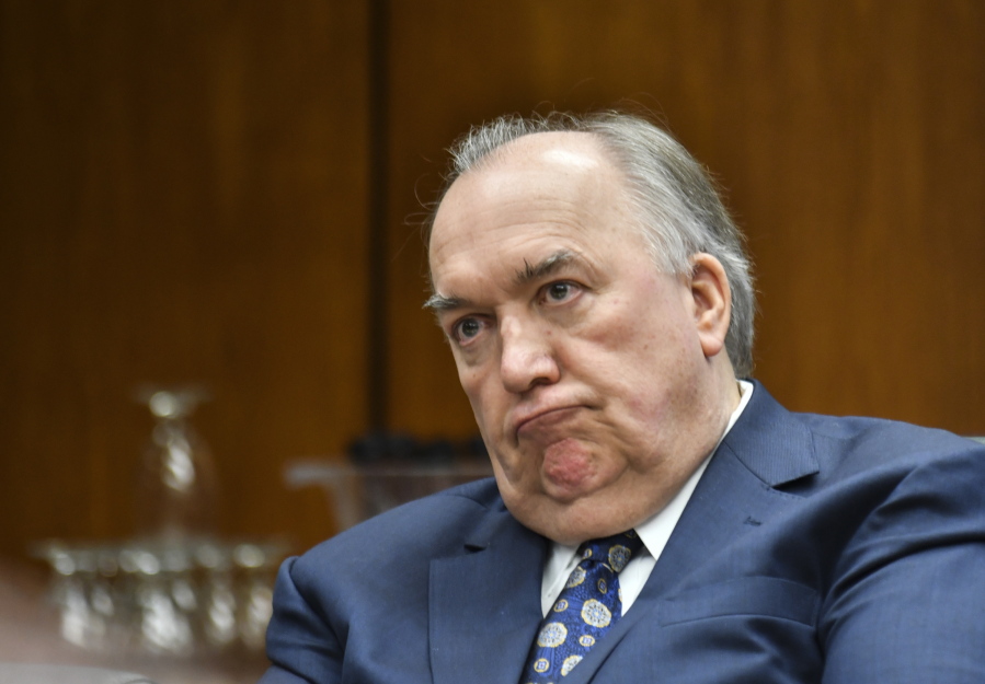 FILE - In this Feb. 16, 2018 file photo, Michigan State University interim President John Engler listens as he runs his first Michigan State University Board of Trustees meeting on campus in East Lansing, Mich. Engler will resign as interim president of Michigan State University amid public backlash over his comments about women and girls sexually assaulted by now-imprisoned campus sports doctor Larry Nassar, a member of the school’s Board of Trustees said Wednesday, Jan. 16, 2019.