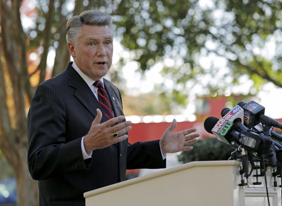 FILE - In this Nov. 7, 2018 file photo Republican Mark Harris speaks to the media during a news conference in Matthews, N.C. The North Carolina board investigating allegations of ballot fraud in a still-unresolved congressional race between Harris and Democrat Dan McCready could be disbanded Friday, Dec. 28 under a state court ruling in a protracted legal battle about how the panel operates. The state Elections Board has refused to certify the race between Harris and McCready while it investigates absentee ballot irregularities in the congressional district stretching from the Charlotte area through several counties to the east. Harris holds a slim lead in unofficial results, but election officials are looking into criminal allegations against an operative hired by the Harris campaign.