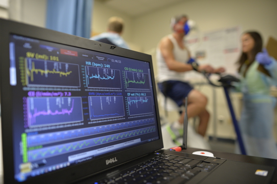 FILE - In this Aug. 27, 2014 file photo, a laptop computer monitors a patient’s heart function as he takes a stress test while riding a stationary bike in Augusta, Ga. A report released on Wednesday, Jan. 30 2019 estimates that nearly half of all U.S. adults have some form of heart or blood vessel disease, a medical milestone that’s mostly due to recent guidelines that expanded how many people have high blood pressure.