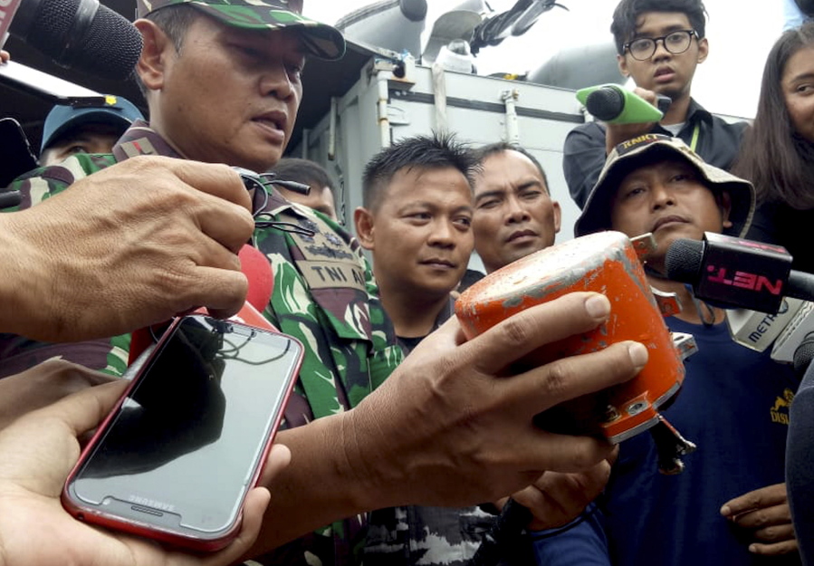Indonesian navy Commander Rear Admiral Yudo Margin shows the recovered cockpit voice recorder of Lion Air Flight 610 that crashed into the sea in October during a press conference Monday.