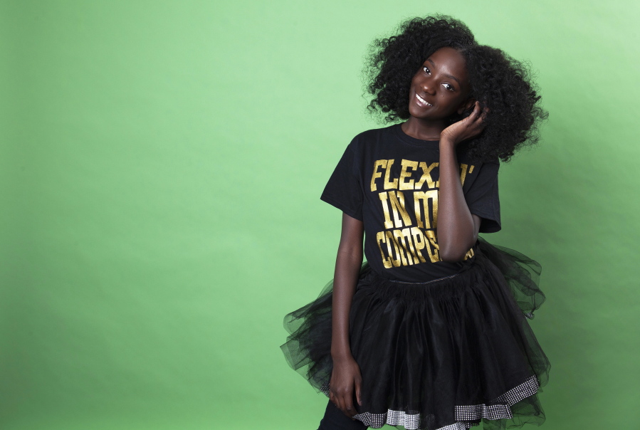 In this Dec. 19, 2018 photo, social media personality Kheris Rogers poses for a portrait in Los Angeles. Rogers launched her own fashion line with T-shirts sporting, “Flexin’ in My Complexion,” along with backpacks reading “The Miseducation of Melanin” and other apparel and accessories.