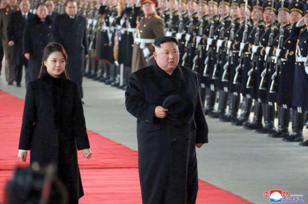 In this Monday, Jan. 7, 2019, photo provided on Tuesday, Jan. 8, 2019 by the North Korean government, North Korean leader Kim Jong Un walks with his wife Ri Sol Ju at Pyongyang Station in Pyongyang, North Korea, before leaving for China. Kim left for China for a four-day trip, the North's state media reported Tuesday, amid speculation that he may attempt to coordinate his positions with Beijing ahead of his likely summit with U.S. President Donald Trump. Independent journalists were not given access to cover the event depicted in this image distributed by the North Korean government. The content of this image is as provided and cannot be independently verified. Korean language watermark on image as provided by source reads: "KCNA" which is the abbreviation for Korean Central News Agency.