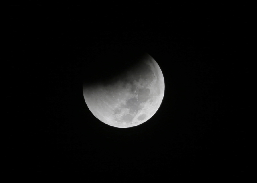 Earth starts to cast its shadow on the moon during a lunar eclipse in August seen from Jakarta, Indonesia.
