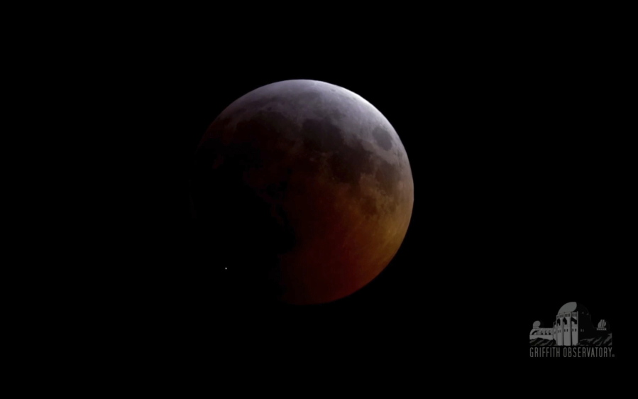 This image from video provided by Griffith Observatory in Los Angeles shows an impact flash on the moon, bottom left, during the lunar eclipse which started on Sunday evening, Jan. 20, 2019. Spanish astrophysicist Jose Maria Madiedo of the University of Huelva said Wednesday, Jan. 23, 2019, it appears a rock from a comet slammed into the moon.