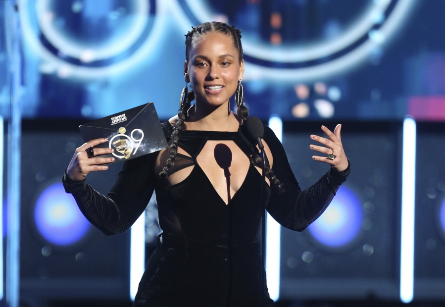 FILE - In this Jan. 28, 2018 file photo, Alicia Keys presents the award for record of the year at the 60th annual Grammy Awards at Madison Square Garden in New York. The Recording Academy announced Tuesday, Jan. 15, 2019, that Keys will host the Feb. 10 Grammys for the first time. The show will air live on CBS in Los Angles.