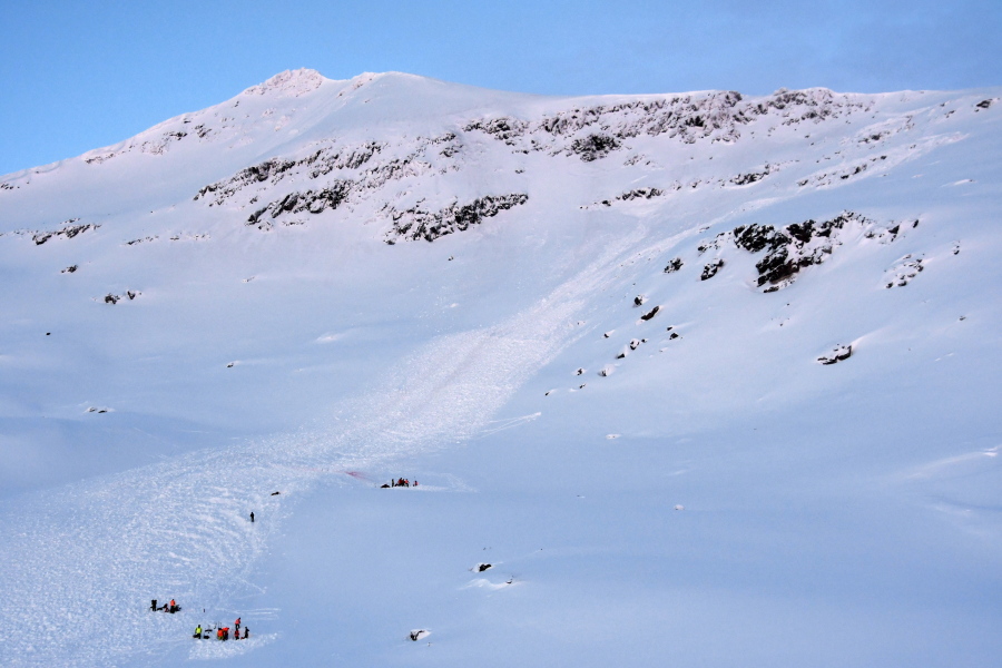 Rescuers, at bottom left, work at the scene of an avalanche Thursday near the northern city of Tromsoe, Norway, where four skiers were swept away more than two weeks ago.