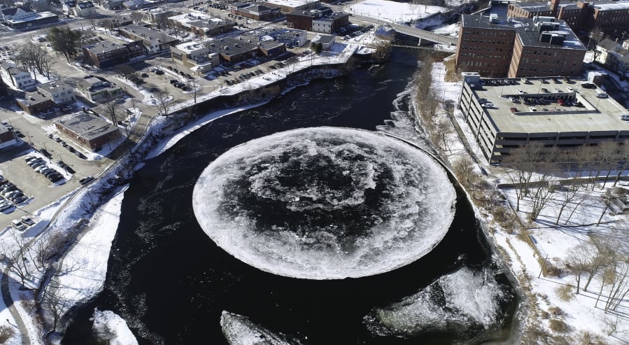 In this Monday, Jan. 14, 2019 aerial image taken from a drone video and provided by the City of Westbrook, Maine, a naturally occurring ice disk forms on the Presumpscot River in Westbrook, Maine.