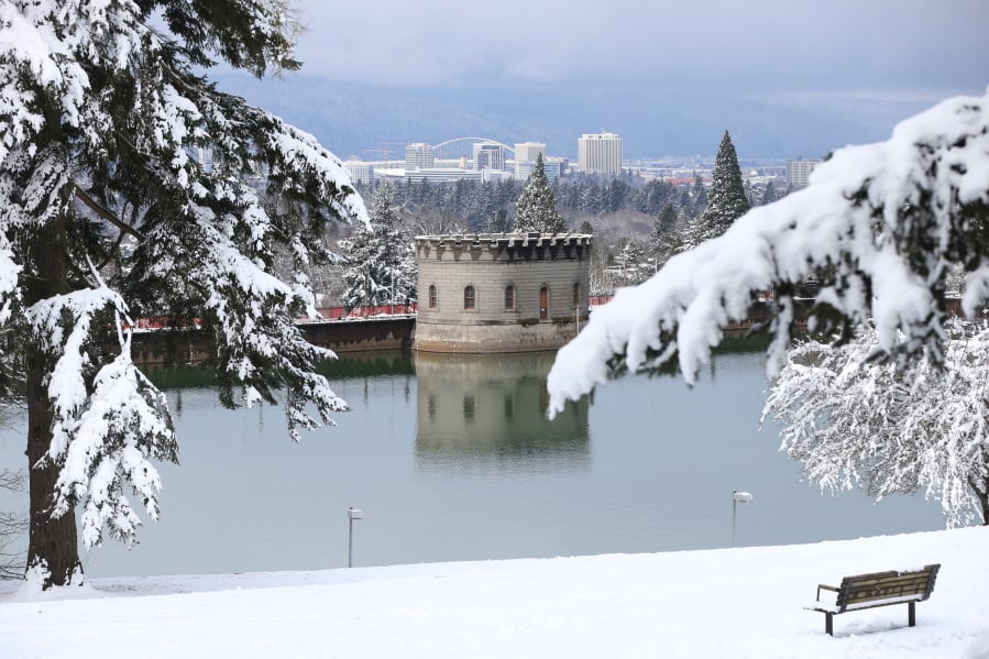 A reservoir on Mount Tabor is framed by snowy scenery on Feb. 22 with a view of the Portland skyline in the distance. A study from Oregon State University says snowpack in the West could begin to be impacted by the effects from climate change.