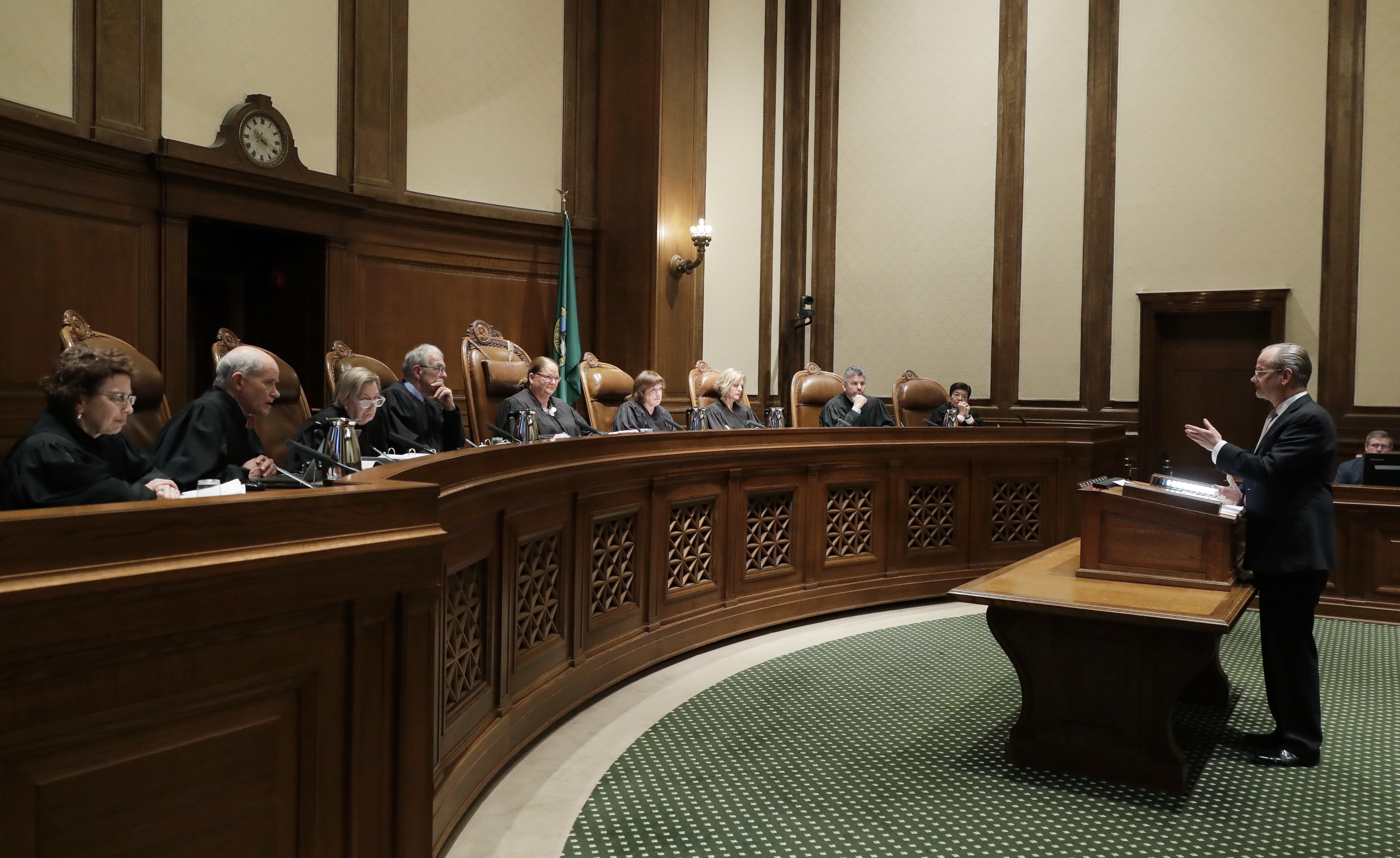 Lawrence Lessig, right, an attorney representing three Washington state presidential electors, speaks Tuesday, Jan. 22, 2019, during a Washington Supreme Court hearing in Olympia, Wash., on a lawsuit addressing the constitutional freedom of electors to vote for any candidate for president, not just the nominee of their party. (AP Photo/Ted S.