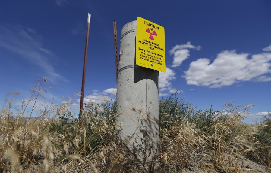In this July 11, 2016, file photo, a sign warns of radioactive material stored underground on the Hanford Nuclear Reservation near Richland. Conservation groups are alarmed by the Trump administration’s proposal to rename some radioactive waste left from the production of nuclear weapons to make it cheaper and easier to achieve permanent disposal. The U.S. Department of Energy is considering a change in its legal definition of high-level radioactive waste, which is stored at places like the Hanford. (Ted S.