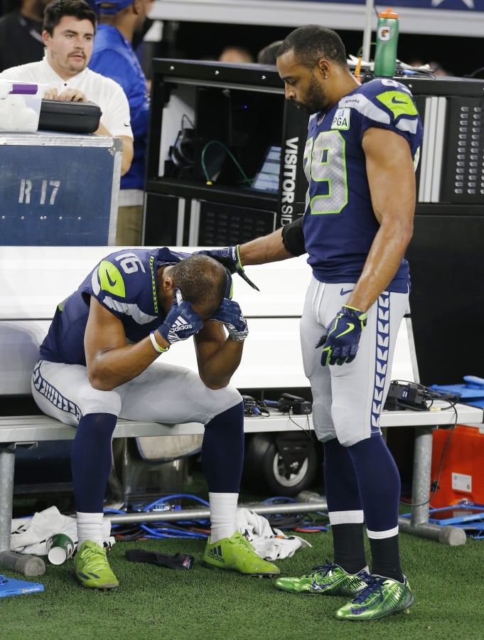 Seattle Seahawks wide receiver Tyler Lockett (16) is consoled by Doug Baldwin (89) after their NFC wild-card NFL football game against the Dallas Cowboys in Arlington, Texas, Saturday, Jan. 5, 2019. The Cowboys won 24-22.