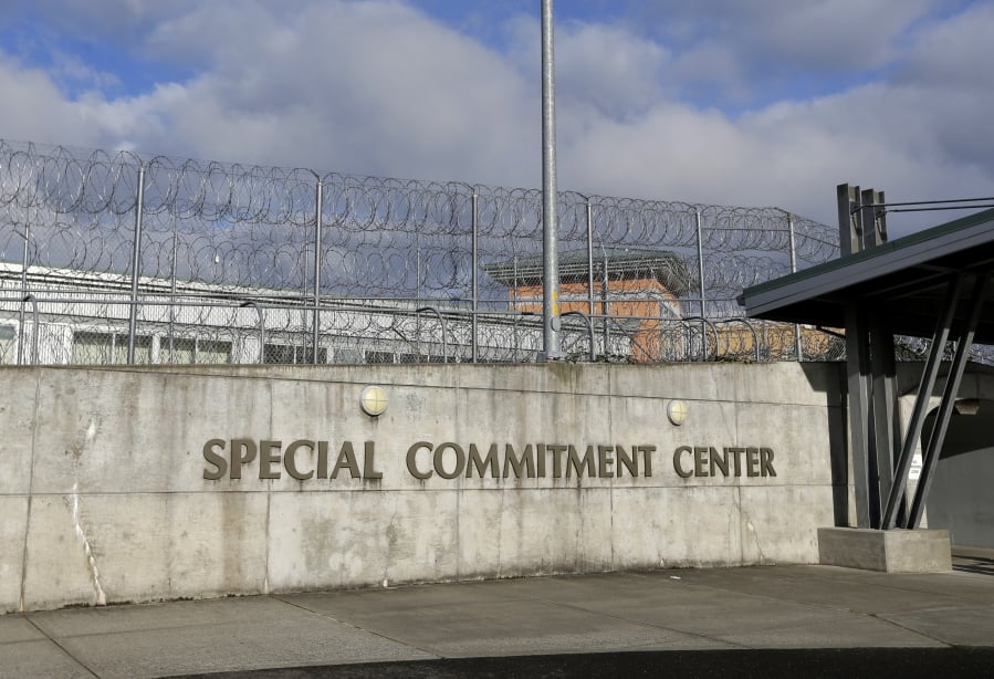 FILE - This Oct. 20, 2015, file photo, shows the main entrance to Washington state’s Special Commitment Center next to a fence lined with razor wire on McNeil Island, Wash. State officials say a sexually violent predator being held at the Special Commitment Center died after suffering a head injury during a fight with another resident. Chris Wright, with the Department of Social and Health Services, said Friday, Jan. 4, 2019, 63-year-old Jerry Spicer suffered a head injury during the fight on Thursday in the facility’s cafeteria. (AP Photo/Ted S.