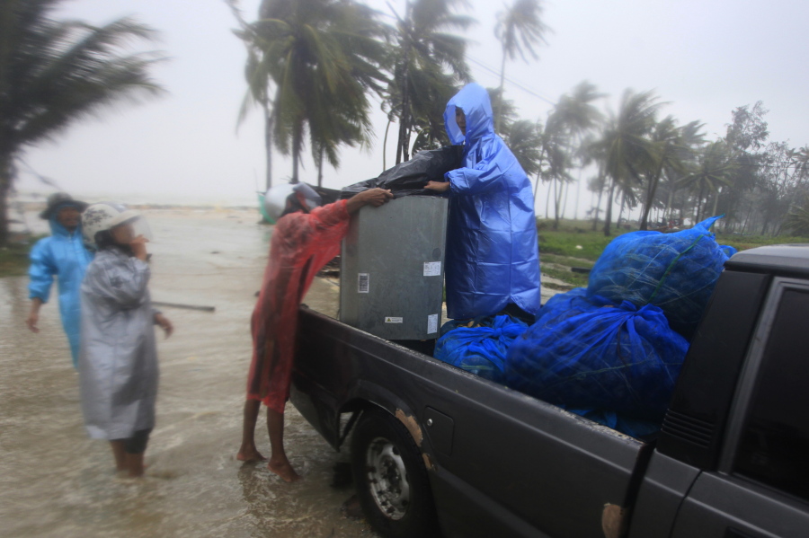 Locals clear out supplies from the coastline in preparation for the approaching Tropical Storm Pabuk, Friday, Jan. 4, 2019, in Pak Phanang, in the southern province of Nakhon Si Thammarat, southern Thailand. Rain, winds and surging seawater are striking southern Thailand as a strengthening tropical storm nears coastal villages and popular tourist resorts.
