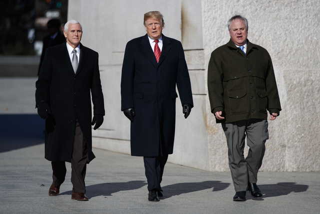 President Donald Trump, center, Vice President Mike Pence, left, escorted by Acting Interior Secretary David Bernhardt, right, visit the Martin Luther King Jr. Memorial, Monday, Jan. 21, 2019, in Washington.