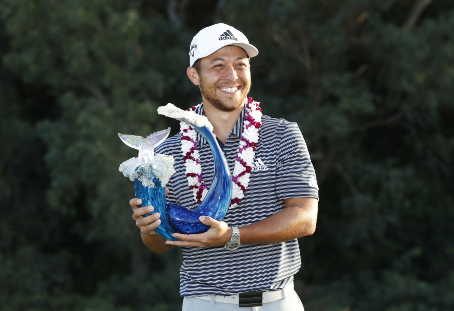 Xander Schauffele holds the champions trophy after the final round of the Tournament of Champions golf event, Sunday, Jan. 6, 2019, at Kapalua Plantation Course in Kapalua, Hawaii.
