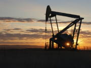 A Whiting Petroleum Co. pump jack pulls crude oil from the Bakken region of the Northern Plains on Nov. 6, 2013, near Bainville, Mont.