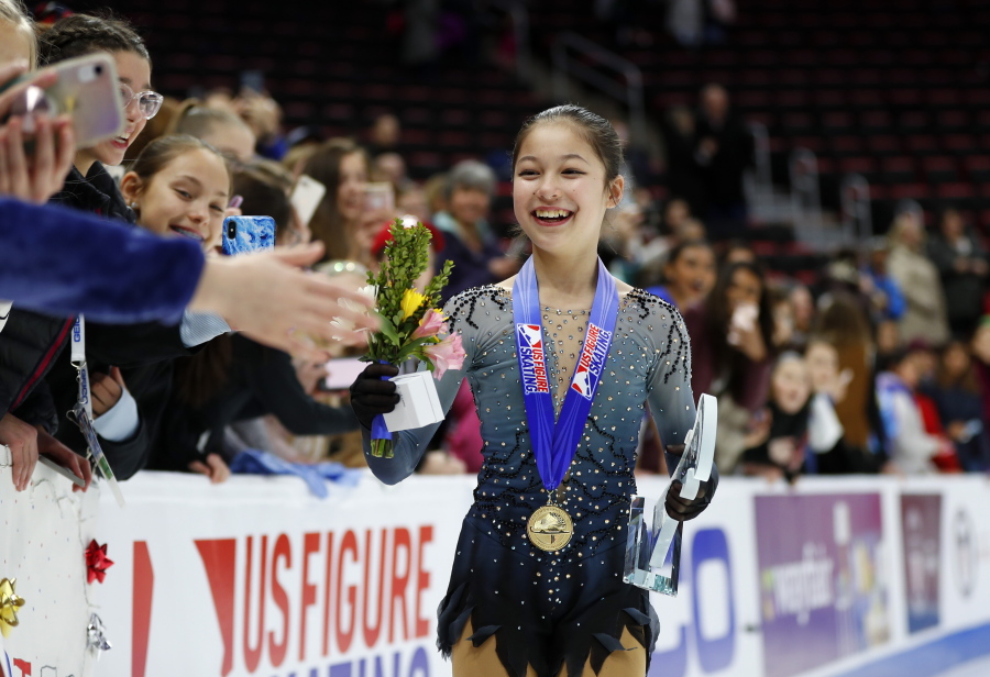 Alysa Liu greets fans while wearing her gold medal after winning the women’s title at the U.S. Figure Skating Championships, Friday, Jan. 25, 2019, in Detroit.