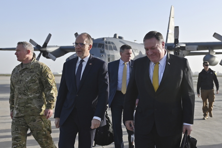 Secretary of State Mike Pompeo, right, is welcomed by U.S. ambassador to Iraq Douglas Silliman, second left, arrives in Baghdad, Iraq, during a Middle East tour, Wednesday, Jan. 9, 2019.