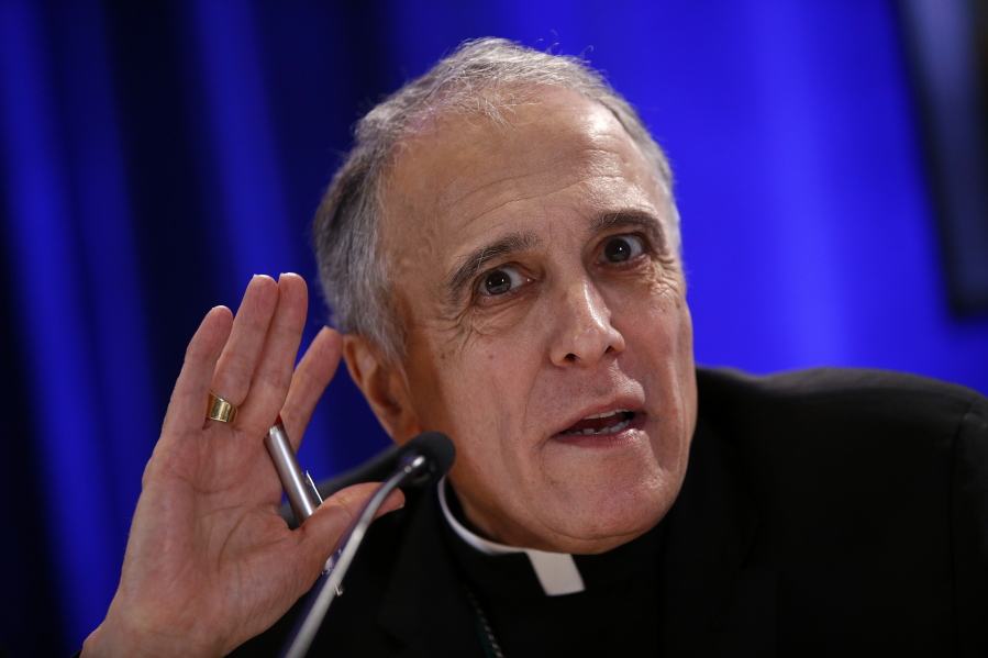 FILE - In this Nov. 12, 2018 file photo, Cardinal Daniel DiNardo of the Archdiocese of Galveston-Houston, president of the United States Conference of Catholic Bishops, listens to a reporter’s question during a news conference during the USCCB’s annual fall meeting, in Baltimore. When Cardinal DiNardo told a stunned meeting of U.S. bishops that the Vatican wouldn’t let them adopt new measures to address clergy sex abuse, he said the Holy See wanted them to wait until after a February abuse prevention summit called by Pope Francis. But a letter from the Vatican’s Cardinal Marc Oullet, obtained this week by The Associated Press, said the main reason the Vatican objected to the November vote was because U.S. bishops had withheld the problematic texts from the Vatican until the last minute, and didn’t consult Rome in drafting them.