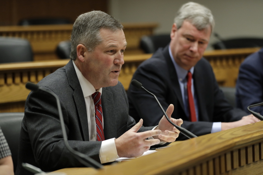 House Minority Leader J.T. Wilcox, R-Yelm, left, speaks as House Majority Leader Pat Sullivan, D-Covington, looks on Thursday during the Leadership Panel of the Associated Press Legislative Preview at the Capitol in Olympia.
