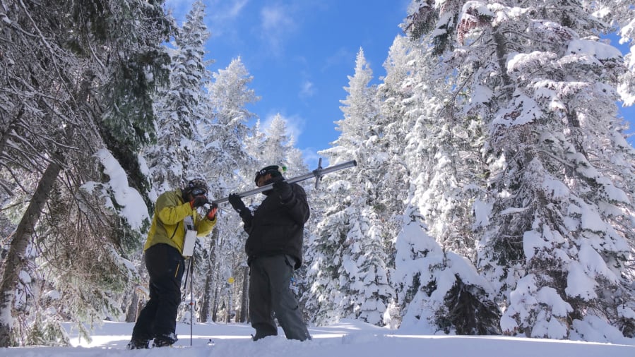 Ben Thorpe, left, and Shavon Haynes measure the snowpack on Mount Ashland.