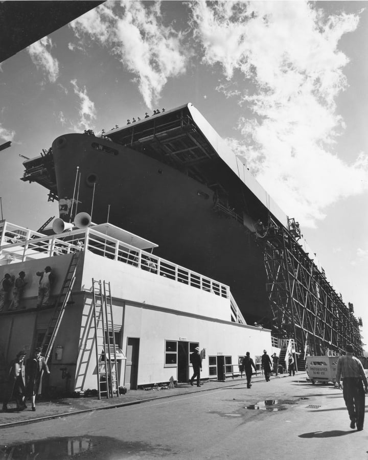 An escort aircraft carrier under construction in Vancouver is photographed by Louis Lee, staff photographer at the Kaiser Shipyard from 1943 to 1945.